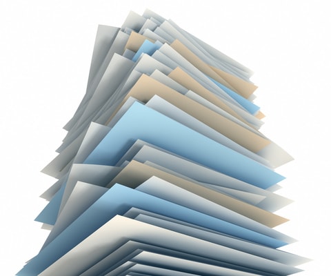 A stack of brain and spinal cord injury fact sheets form a pile blue, tan and white paper.